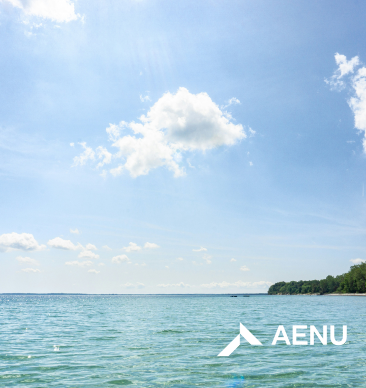 The ocean and island with blue sky and the AENU logo